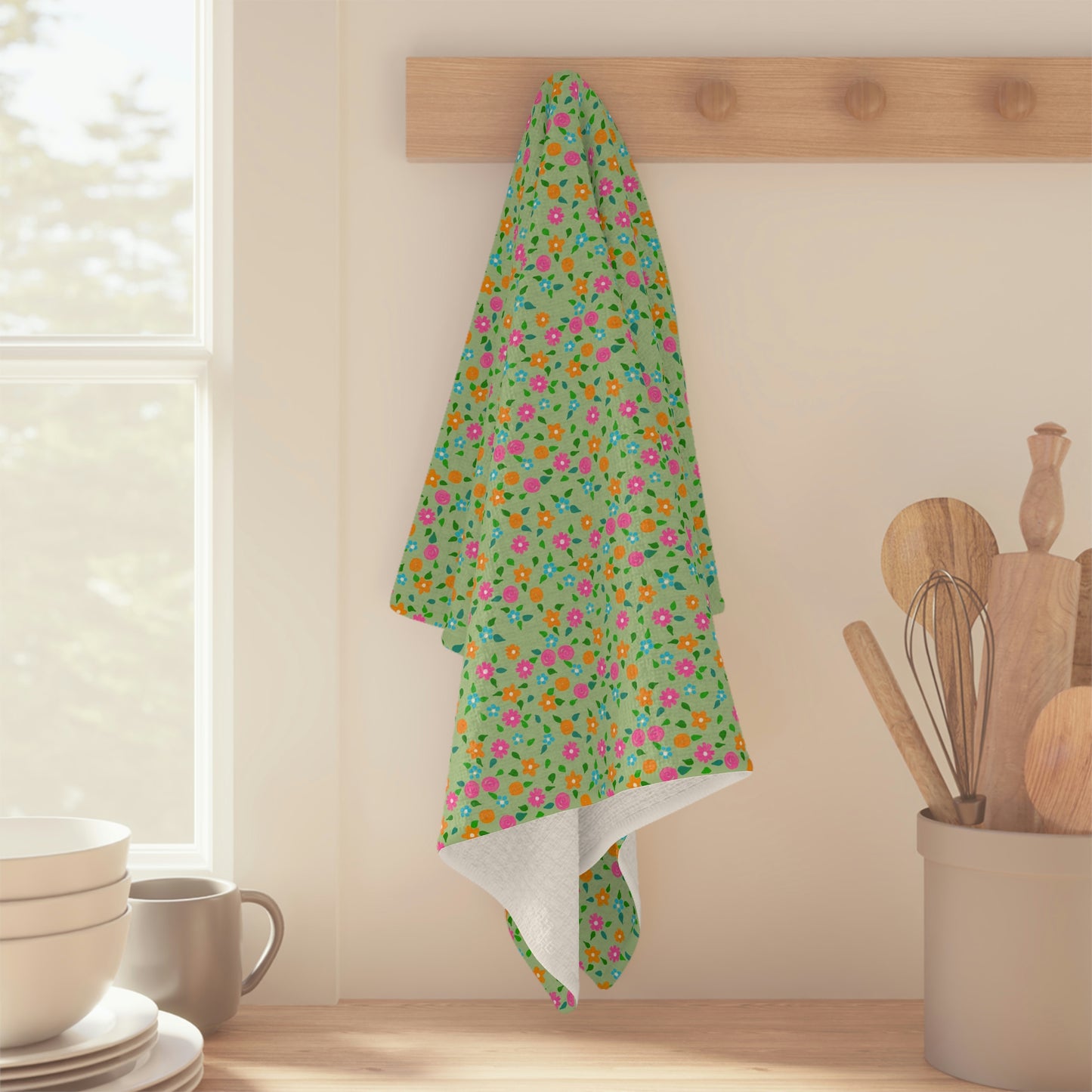 A multi-coloured, loose floral on a bright green background makes this tea towel a great addition to your kitchen! Artwork by Bridget M. Designs.